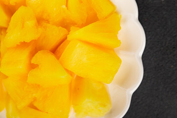 Pineapple canned chunks sweet fruit dessert tasty snack fresh delicious gourmet food background on the table rustic top view copy space keto and paleo diet vegetarian and vegan food