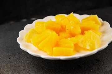 Pineapple canned chunks sweet fruit dessert tasty snack fresh delicious gourmet food background on the table rustic top view copy space keto and paleo diet vegetarian and vegan food