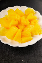 Pineapple canned chunks sweet fruit dessert tasty snack fresh delicious gourmet food background on the table rustic top view copy space keto and paleo diet vegetarian and vegan food