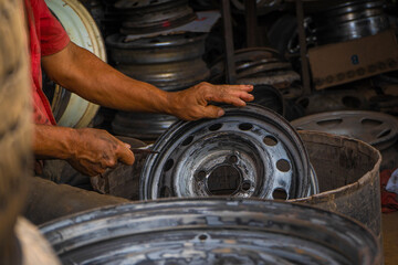 Mechanic working on the street fixing a car 