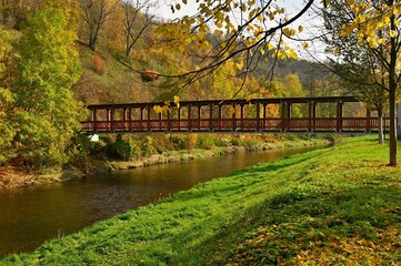 Beautiful old wooden bridge over the river in autumn time. Oslavany - Czech Republic.