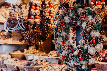 Handmade Pinecone Wreaths With Red Berries On Festive Market Stall
