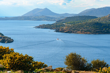Red Boat Sailing Through Calm Aegean Waters Near Sounion
