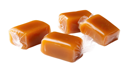 Four wrapped caramel candies, light amber color, close-up