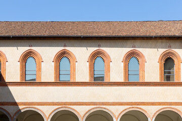 walls with windows of an ancient yellow European castle