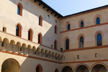 walls with windows of an ancient yellow European castle