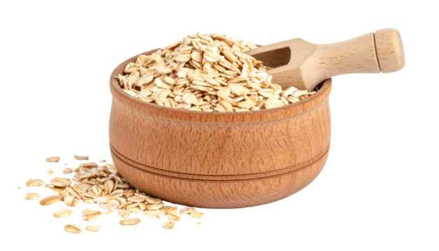 Rolled oats in wooden bowl with scoop; some oats spilled. Isolated on black