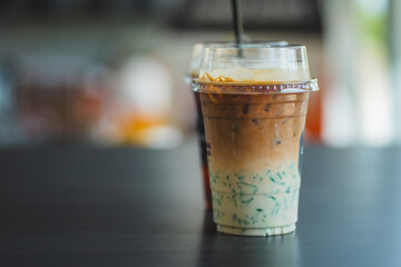 Two glasses of iced coffee on table in coffee shop.