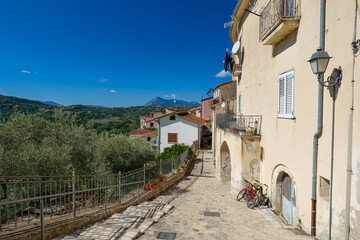 A narrow street among the old houses of Chianche. a village in the province of Avellino, Italy.