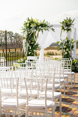Wedding decor with fresh anthurium flowers, hydrangeas and greenery outdoors near the water. Wedding 