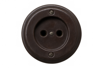 Round retro bakelite style wall socket providing electricity, showing old technology and power connection