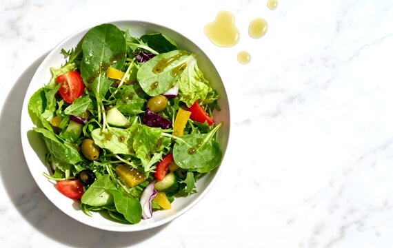Vibrant fresh mixed green salad, crisp lettuce, colorful tomatoes, bell peppers, olives, light vinaigrette dressing in white bowl, healthy and delicious meal