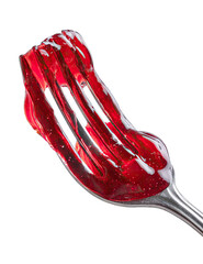 Red jelly clinging to a fork's tines