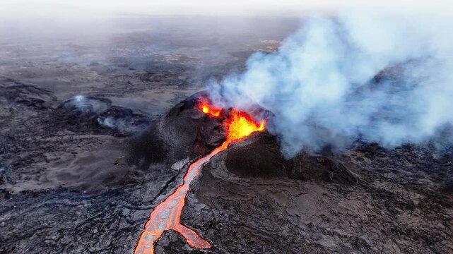 A breathtaking bird's-eye view, likely captured by a drone, shows an active volcanic fissure erupting. From above, the glowing orange veins of the lava river create a stark contrast against the dark.