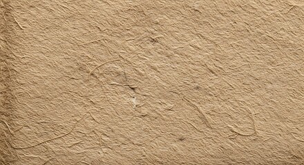 Closeup view of a textured, rough, and natural brown paper surface with subtle variations in tone and grain