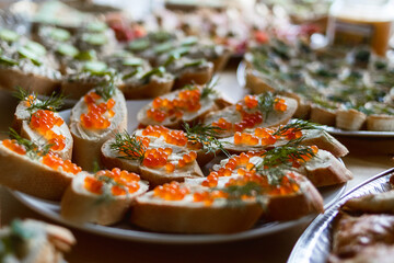 Close-up of sandwiches with butter and caviar on festive table