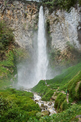Majestic waterfall cascading down rocky cliff nature scene outdoor adventure lush green environment scenic viewpoint