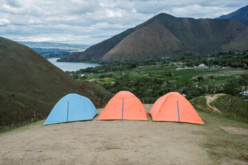 Camping adventure in scenic mountains outdoor tents set against nature's beauty wide angle view