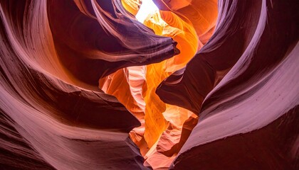 Antelope Canyons vibrant sandstone walls illuminated by a shaft of light, showcasing the natural beauty of the slot canyon.