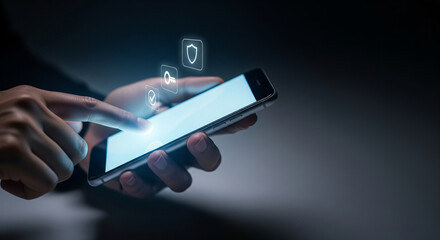 Persons hand holding a smartphone with a blank screen, with digital security icons appearing above, illustrating mobile security, app protection, and online safety