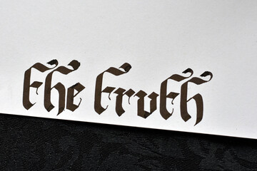Handwritten ''the truth'' in gothic calligraphy