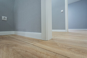 closeup of oak laminate flooring, floor laminate featuring oak planks and decorative trim visible,...