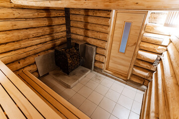 large cozy sauna, spacious sauna with lighting, wideangle view of comfortable sauna interior, expansive sauna scene featuring furniture and ambient lighting for relaxation