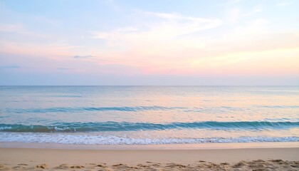 Obraz premium Firefly pastel pink and blue sunset over calm ocean beach with waves crashing against the shore