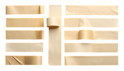 Various tan paper tape pieces and a roll arranged on a dark background