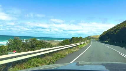 Car journey along the Great Ocean Road with coastal views and greenery – 4K