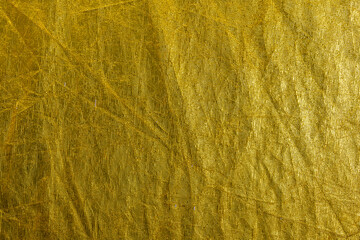 Gold foil leaf shiny metallic wrapping paper texture background for wall paper decoration element