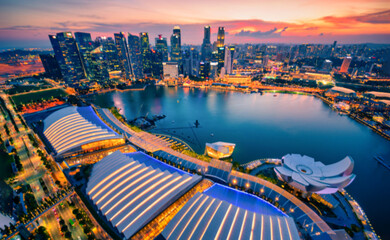Blurred abstract background lights, beautiful cityscape view of Singapore city skyline at sunset.