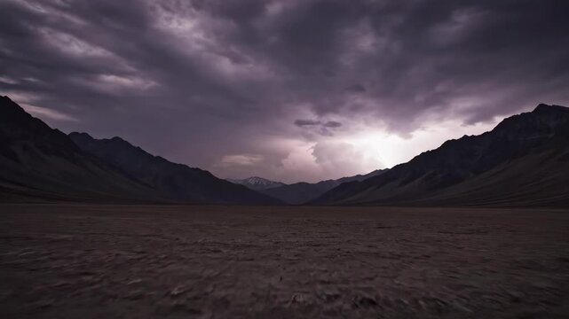 Slow pan across a vast, empty valley floor under a dramatic stormy sky vast empty valley floor, powerful sky, desolate