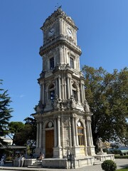 Dolmabahçe Clock Tower in Istanbul under Clear Blue Sky, Historical Ottoman Architecture and...
