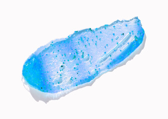 Shimmering blue gel swatch with exfoliating microbeads on white background.