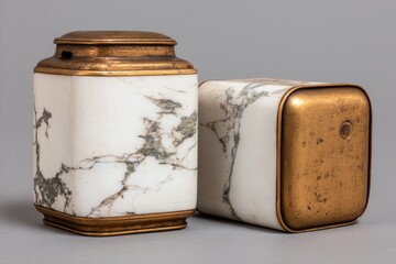 Two vintage marble and brass containers with decorative patterns.