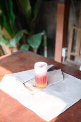 Refreshing layered drink with tropical vibes, perfect for summer brunch or a vibrant cafe menu, ready to quench your thirst on a sunny day