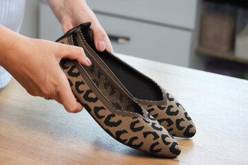 Woman unboxing and reviewing leopard print shoes Summer boat shoes
