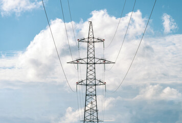 High voltage metal pillar with power line wires. Front view.