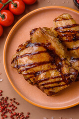 Grilled boneless chicken legs baked on the barbecue for lunch. Grilled chicken as a background