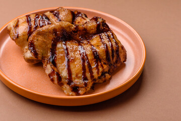 Grilled boneless chicken legs baked on the barbecue for lunch. Grilled chicken as a background