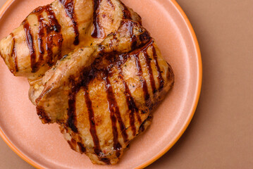 Grilled boneless chicken legs baked on the barbecue for lunch. Grilled chicken as a background