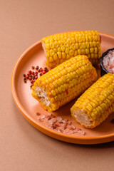 Corn cob cooked in chunks, vegetables, healthy vegetarian food. Boiled corn as a background