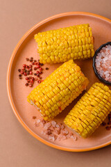 Corn cob cooked in chunks, vegetables, healthy vegetarian food. Boiled corn as a background