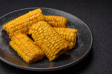 Corn cob cooked in chunks, vegetables, healthy vegetarian food. Boiled corn as a background