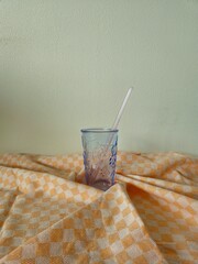glass with multi-colored straws. Reusable glass Straws in Glass on white background. empty glass with colorful straws on a white background.