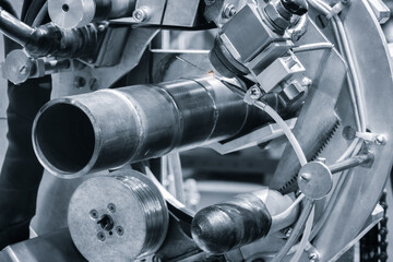 Metal pipe fixed in tank for cutting or welding with modern welding machine, industrial concept background