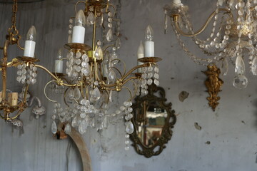 Antique chandelier at Tbilisi flea market. Old brass chandelier with ornate metal details and glass shades hanging at a flea market in Tbilisi, Georgia. Vintage decor concept.