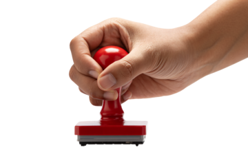 Hand holding red rubber stamp for approval or official document