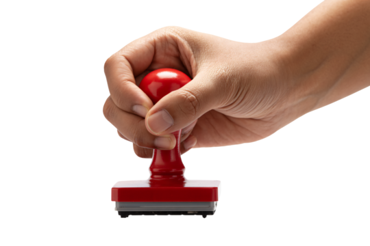 Hand holding red rubber stamp for approval or official document